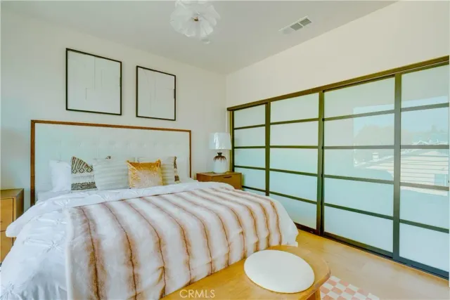 a bedroom with a bed and a window