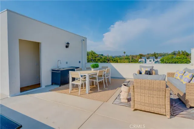 a view of a terrace with a table and chairs