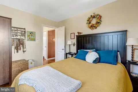 a bedroom with a large bed and a chandelier