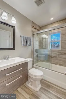 a bathroom with a toilet sink and a shower