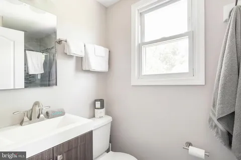 a bathroom with a sink toilet and mirror