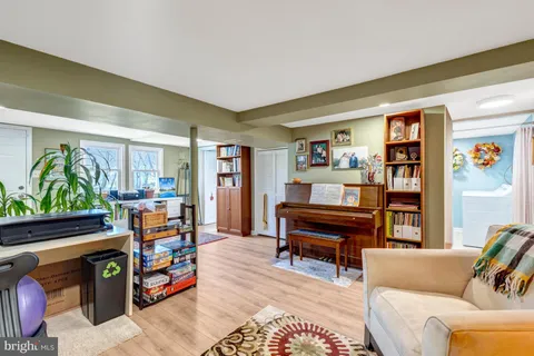 a living room with furniture and a piano
