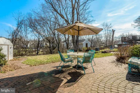a view of a table and chairs under an umbrella
