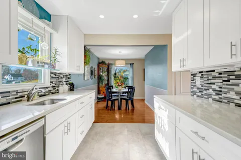 a kitchen with stainless steel appliances kitchen island granite countertop a sink and cabinets