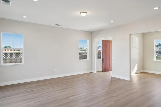 a view of a kitchen with wooden floor and a sink