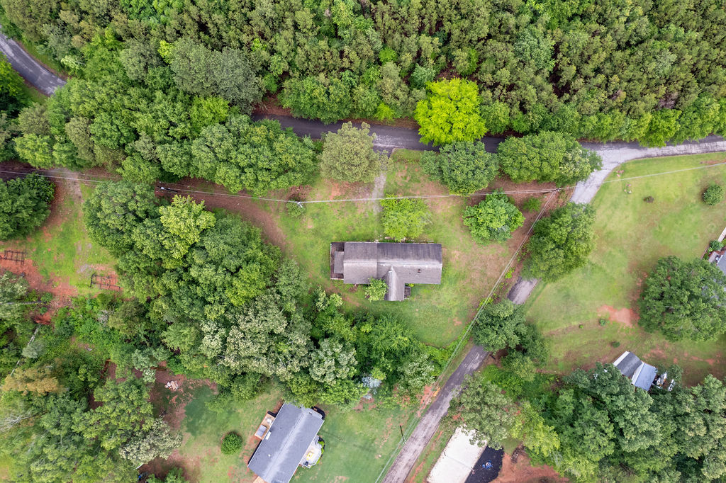 712 Whitney Way Anderson, SC 29625 - Photo 4 of 31 An aerial perspective reveals a secluded home nestled amidst dense, verdant woodlands, with winding access roads.
