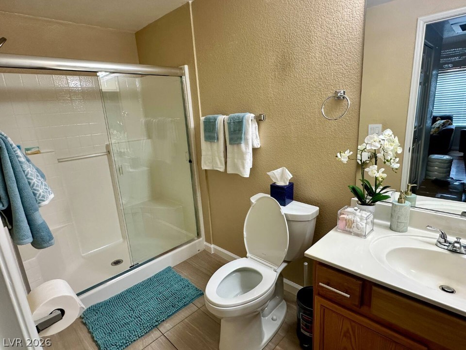 9580 West Reno Avenue, Unit 169 Las Vegas, NV 89148 - Photo 14 of 15 A well-appointed bathroom with a clear glass shower and functional vanity for daily routines.