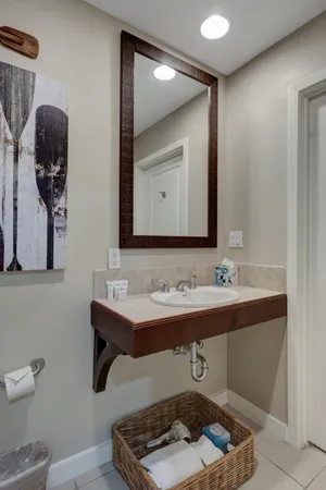 a bathroom with a sink a light fixture and a toilet