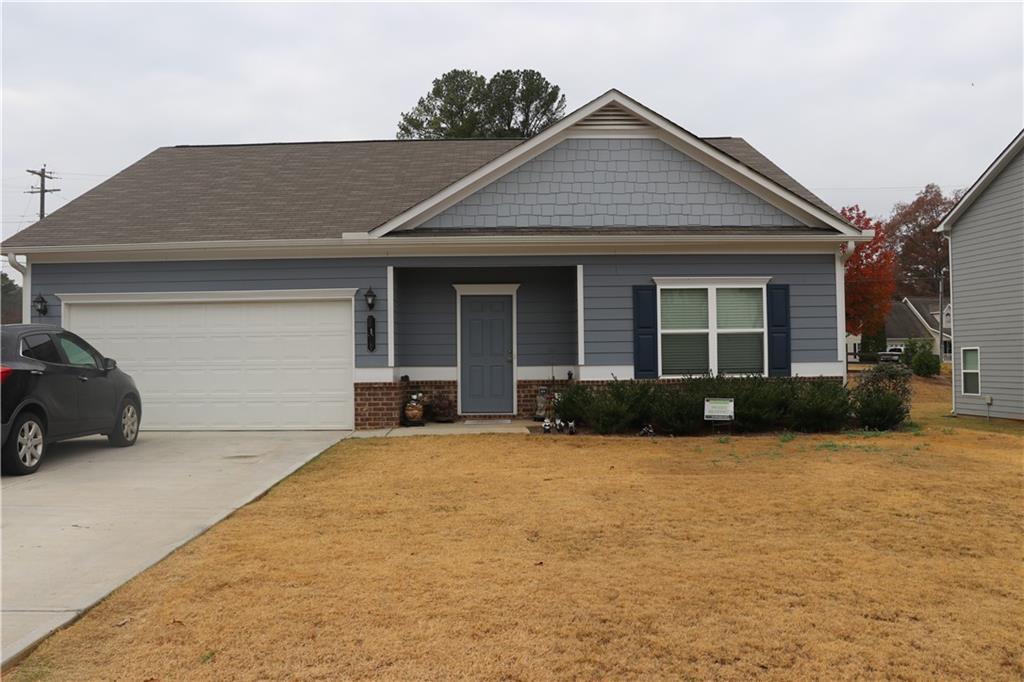 a front view of a house with yard and garage