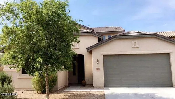 a side view of a house with a tree