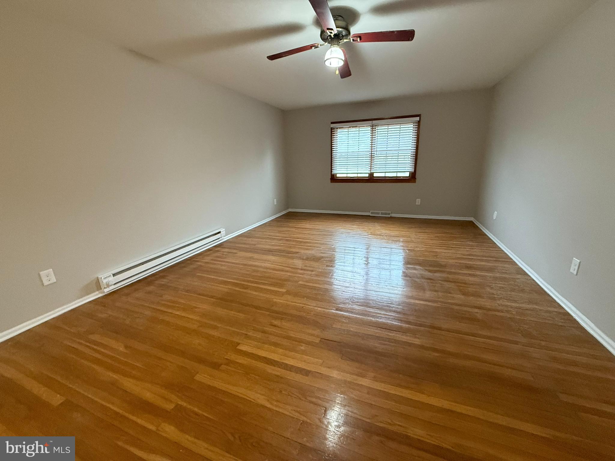745 Windsor Place Wallingford, PA 19086 - Photo 15 of 33 wooden floor in an empty room with a window