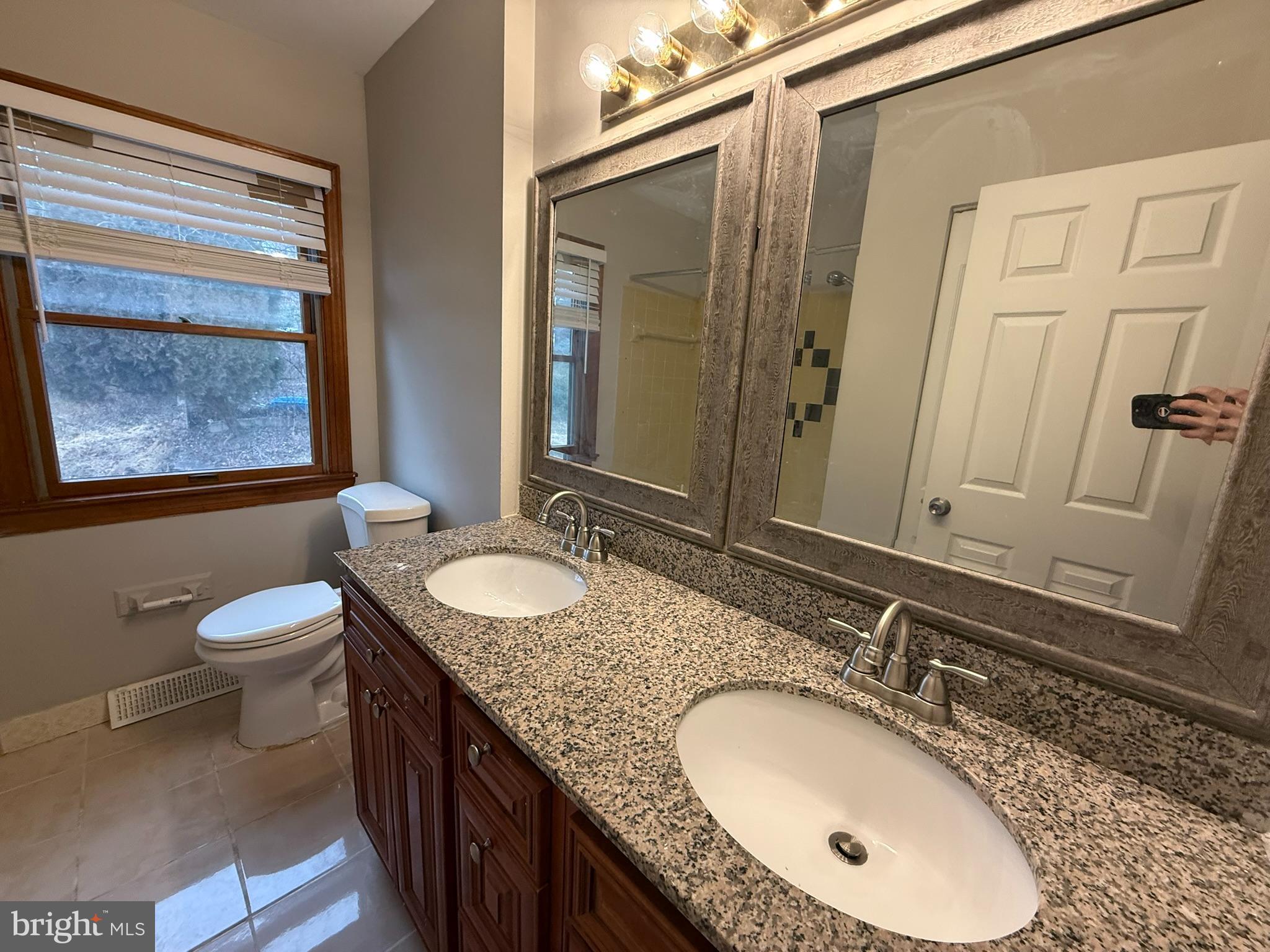 745 Windsor Place Wallingford, PA 19086 - Photo 19 of 33 a bathroom with a granite countertop double vanity sink and a mirror