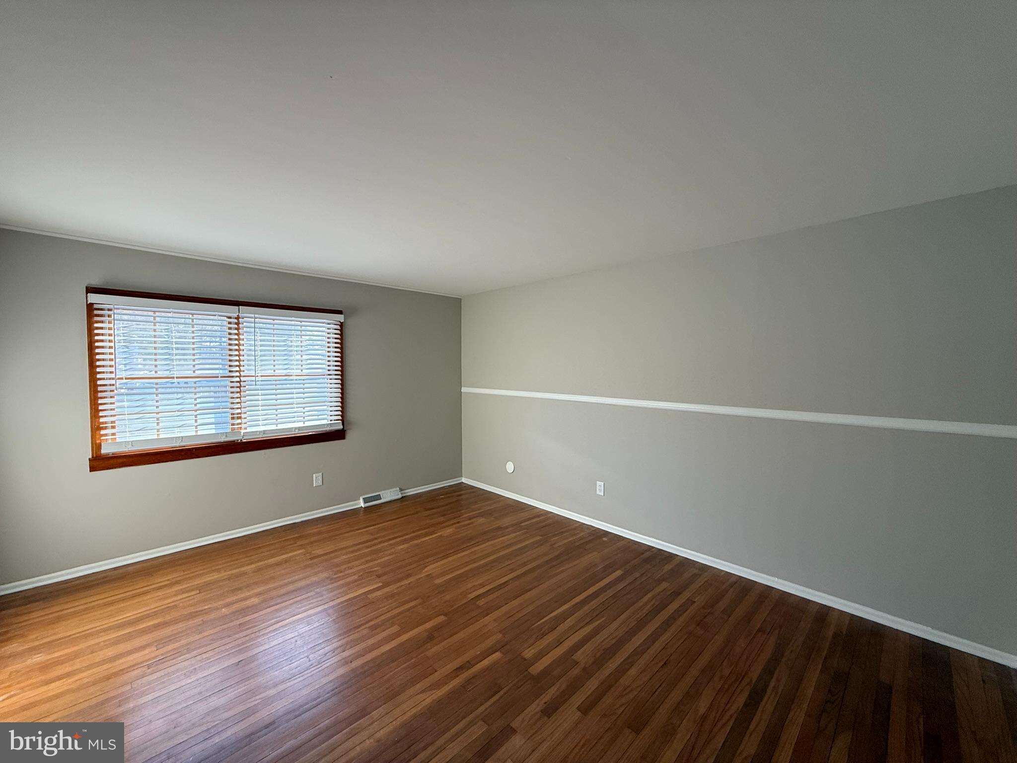 745 Windsor Place Wallingford, PA 19086 - Photo 20 of 33 a view of an empty room with wooden floor and a window