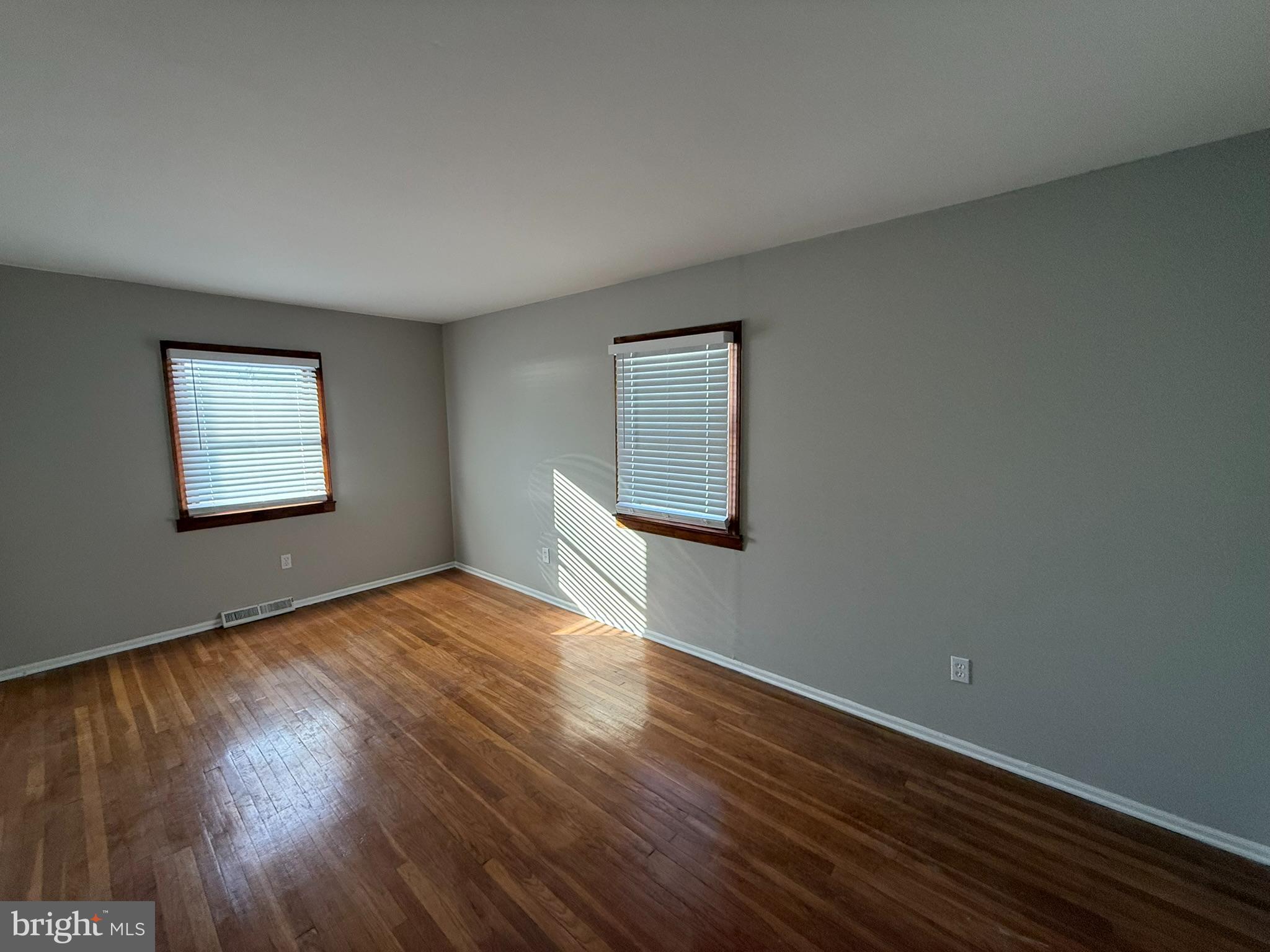 745 Windsor Place Wallingford, PA 19086 - Photo 22 of 33 a view of an empty room with wooden floor and a window