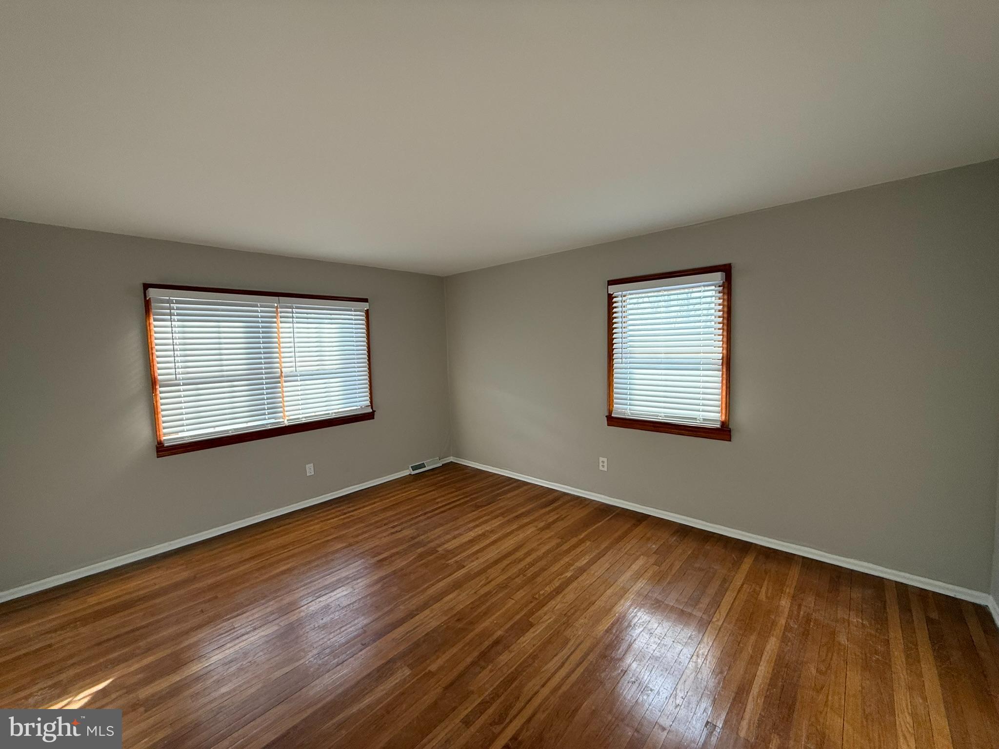 745 Windsor Place Wallingford, PA 19086 - Photo 24 of 33 a view of an empty room with wooden floor and a window