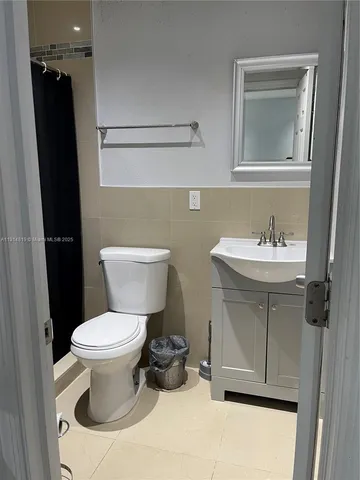 a bathroom with a sink toilet and a mirror