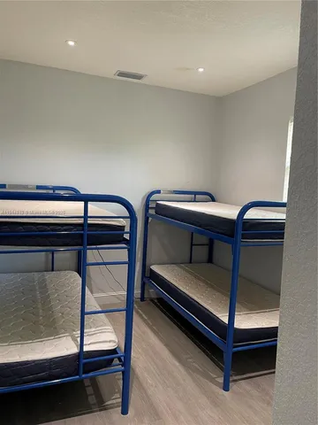 a bedroom with bunk bed and a desk