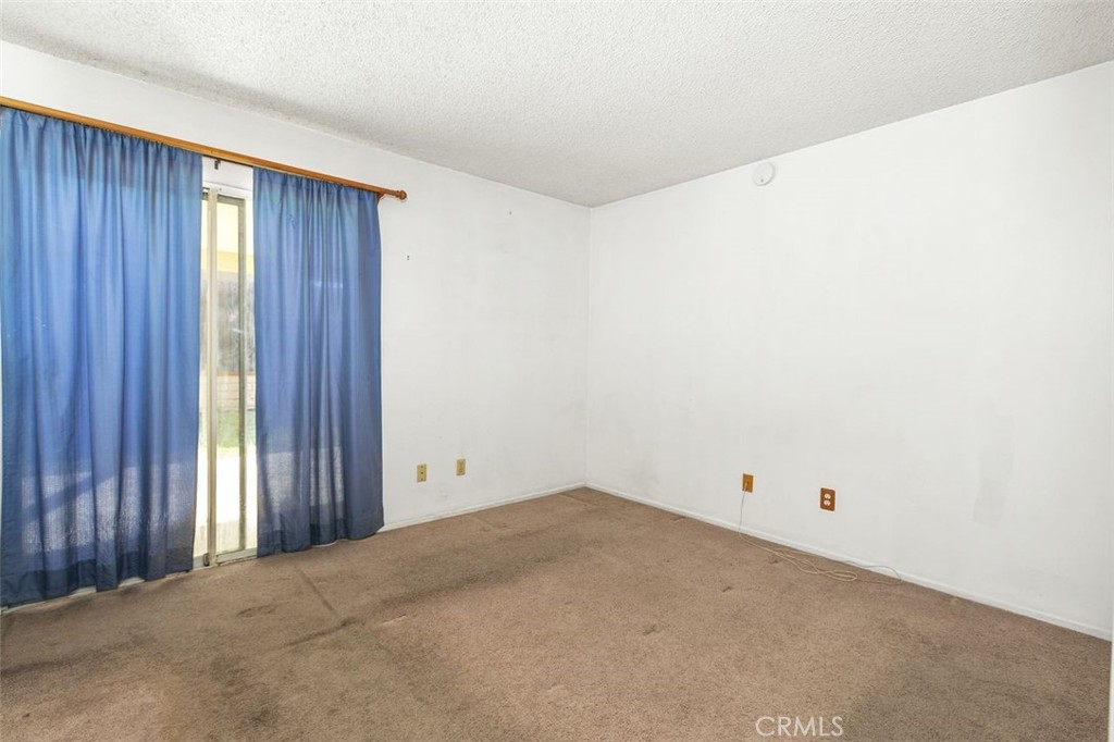 1168 Athena Court Riverside, CA 92507 - Photo 15 of 29 Primary Bedroom with sliding door access to the patio area. The sliding doors allow this room to be flooded with natural light.