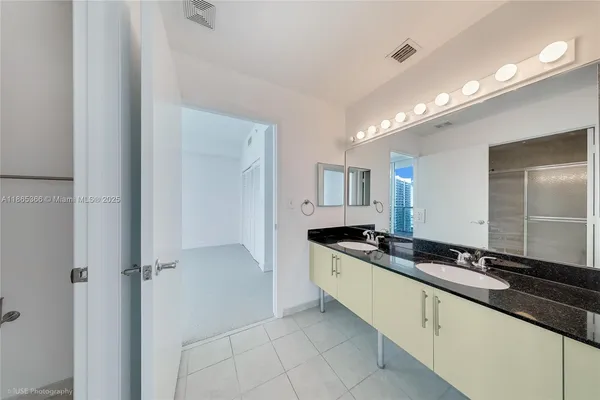 a large bathroom with a sink and a mirror