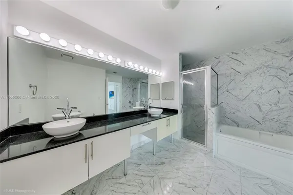 a bathroom with a granite countertop sink a toilet and bathtub