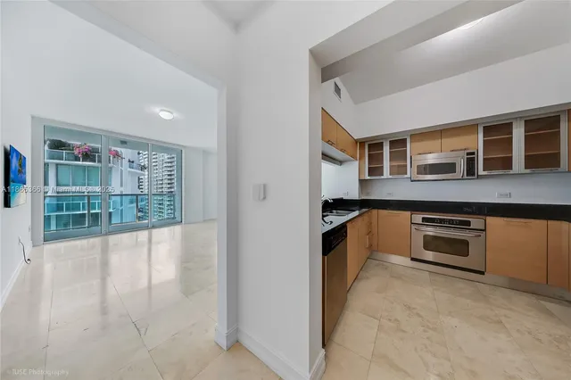 a view of a kitchen with a sink and cabinets