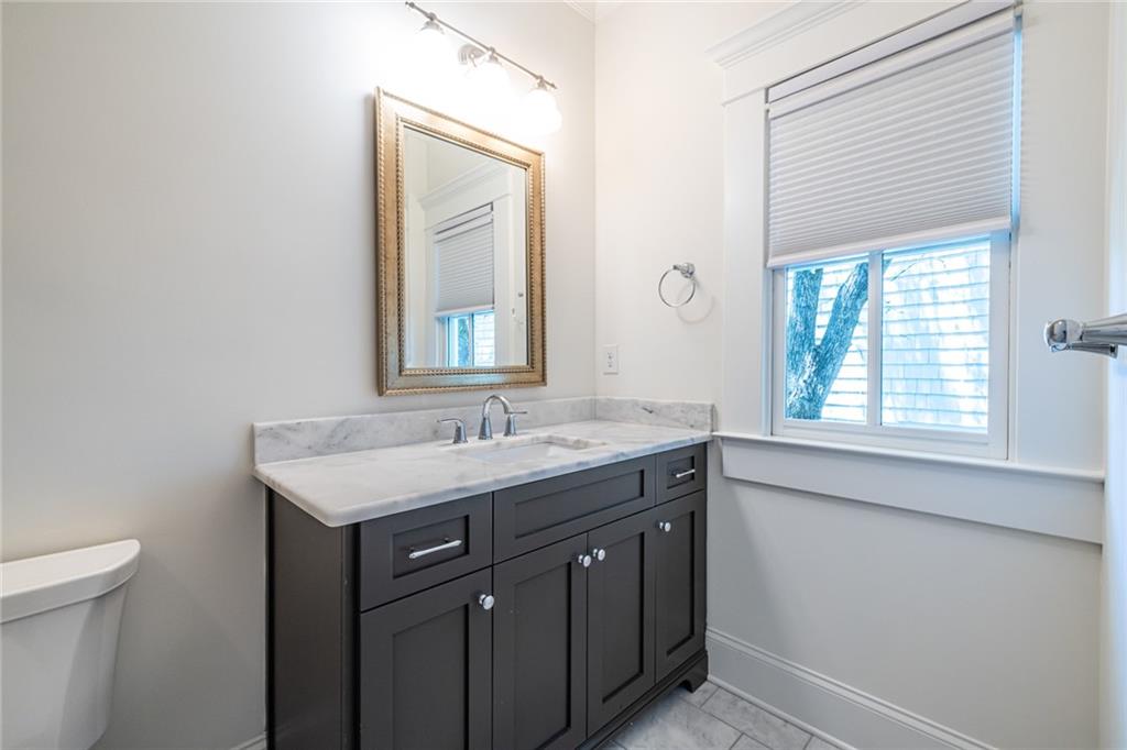 538 Ansley Street Decatur, GA 30030 - Photo 43 of 73 a bathroom with a granite countertop sink a toilet and a mirror
