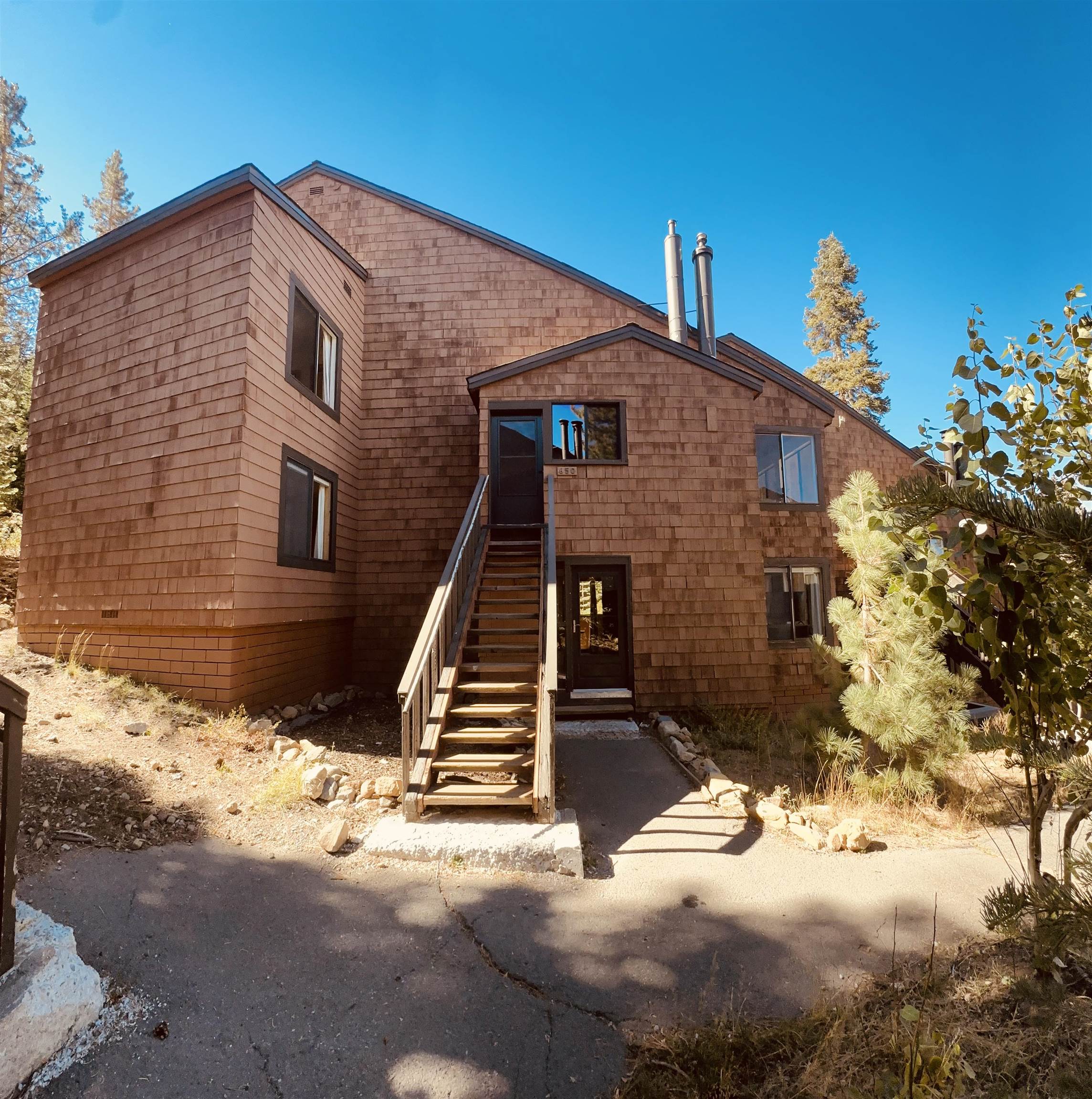 11567 Snowpeak Way, Unit 649 Truckee, CA 96161 - Photo 1 of 20 a front view of a house with a yard
