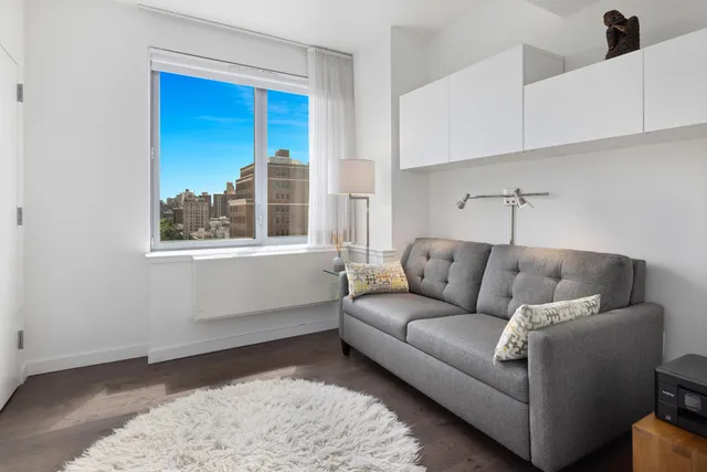 a bathroom with a sink vanity mirror and toilet