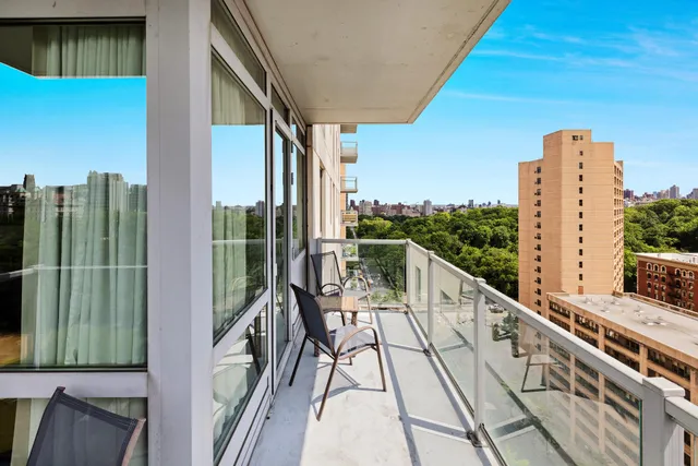 a living room with furniture a flat screen tv and a floor to ceiling window