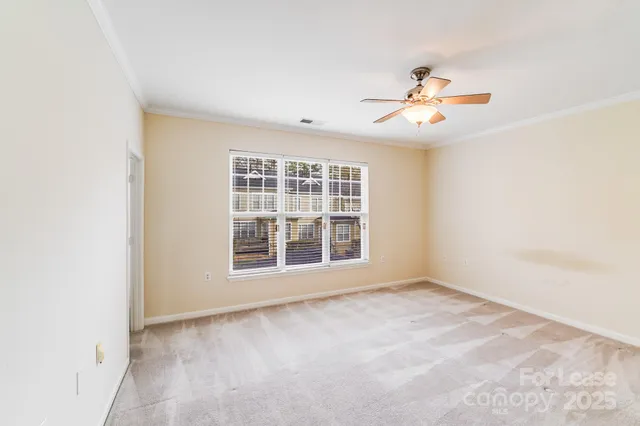 a view of an empty room and a window