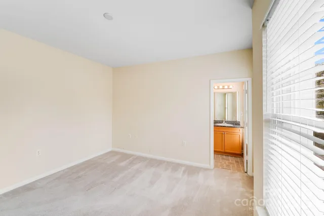 a bathroom with a granite countertop sink mirror and a bathtub