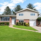 a front view of a house with a yard and porch