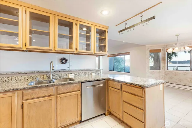 a kitchen with stainless steel appliances granite countertop white cabinets and a sink