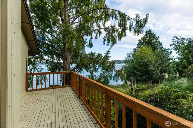 a view of balcony with wooden floor and fence