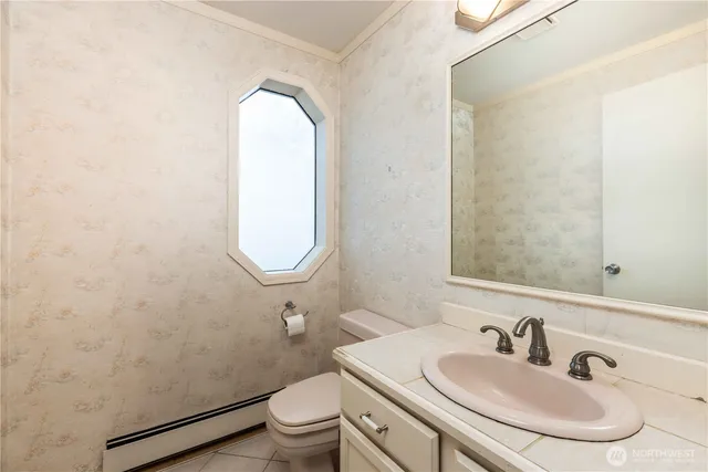 a bathroom with a toilet sink and mirror