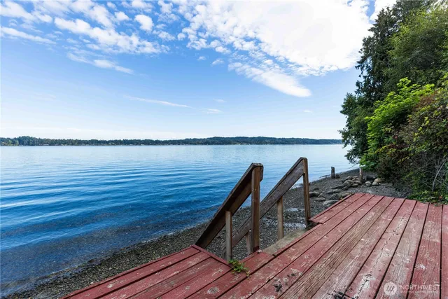 a view of a balcony with wooden floor and seating space