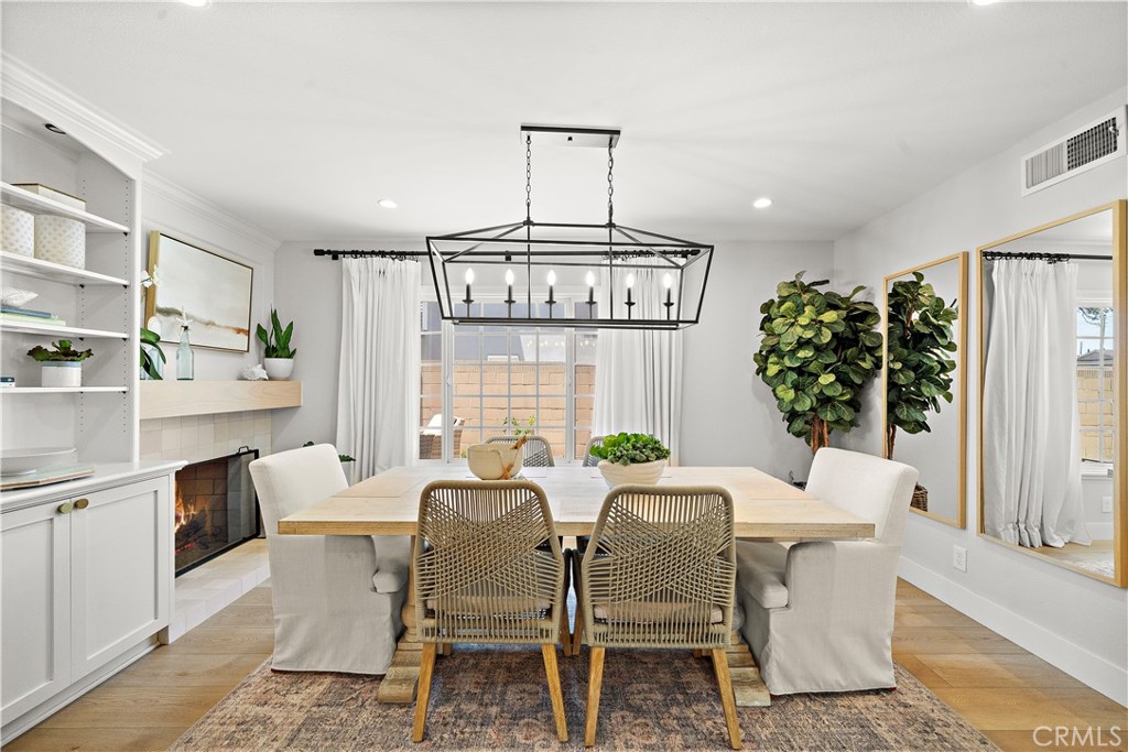 8741 La Roca Avenue Fountain Valley, CA 92708 - Photo 11 of 50 Dining room with fireplace and custom built-in shelving and cabinetry