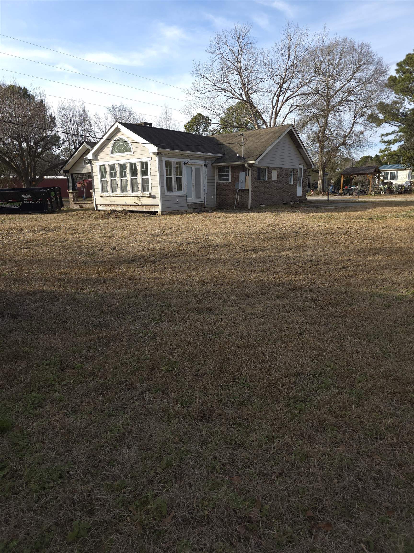 1795 Star Bluff Road Longs, SC 29568 - Photo 26 of 26 Back of house featuring a lawn and brick siding