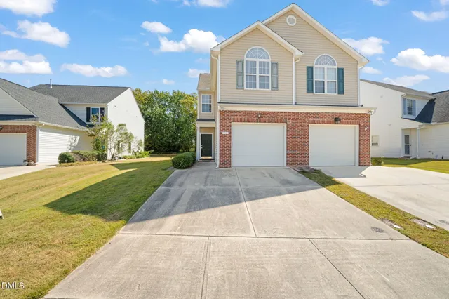 a view of a white house with a yard