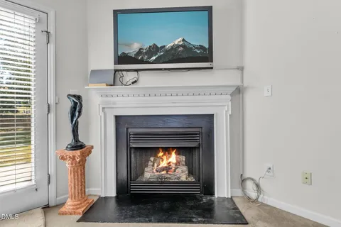 a living room with a fireplace and a fireplace