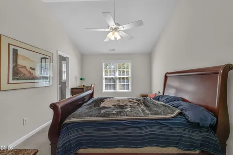a bed sitting in a bedroom next to a window
