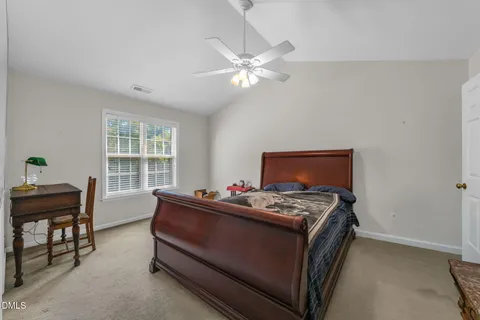 a bedroom with furniture and a window