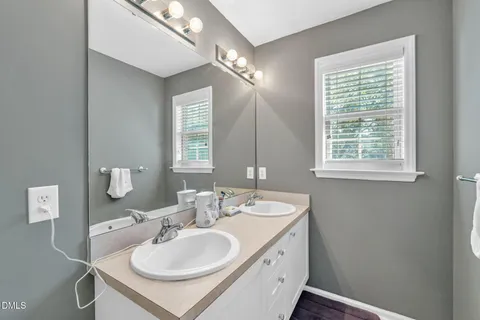 a bathroom with a sink double vanity and a mirror