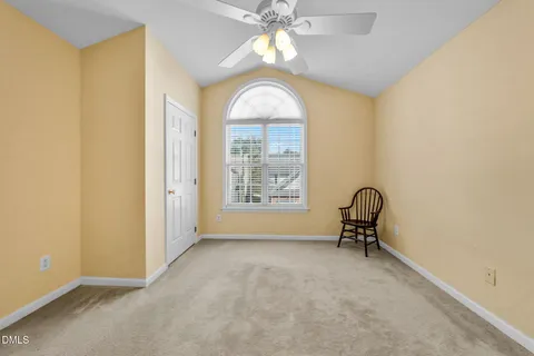 a view of a livingroom with a window and a chair