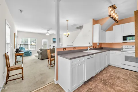 a large kitchen with a table and chairs