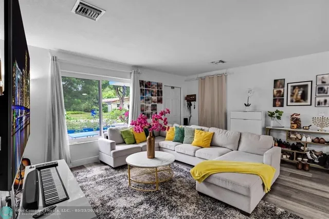 a living room with furniture and a large window