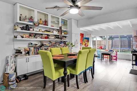 a dining room with furniture and wooden floor