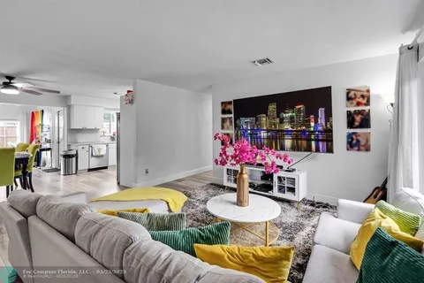a living room with furniture and flowers