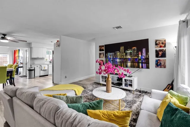 a living room with furniture and flowers