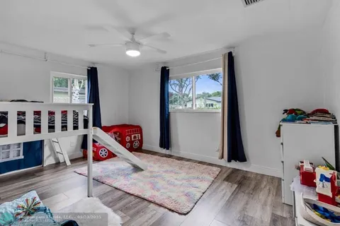 a bedroom with furniture and a book shelf